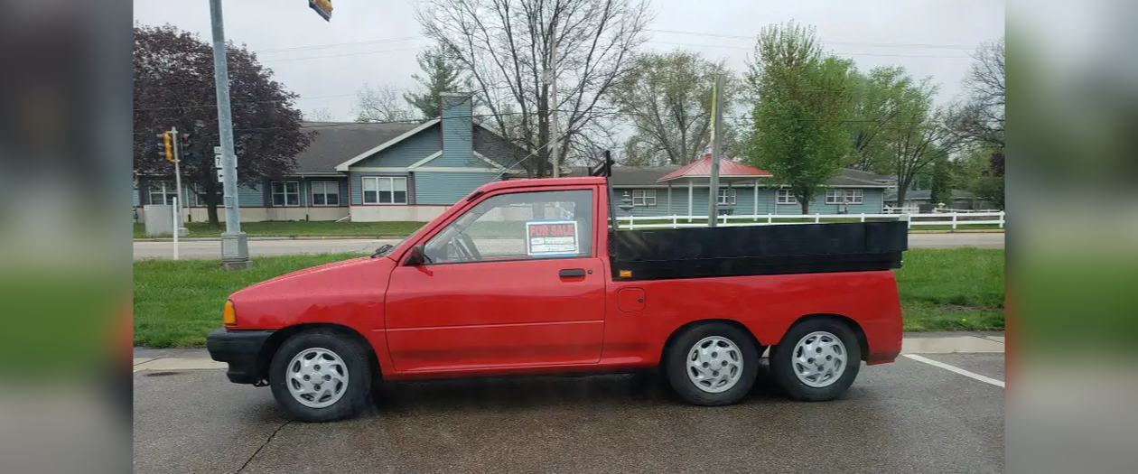 A Six Wheeled Ford Festiva Hatchback Made Pickup is For Sale in Wisconsin